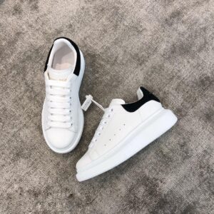 Black fur Alexander McQueen white leather snakeskin sneakers