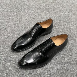 Louis Vuitton carved leather dress shoes with decorative details