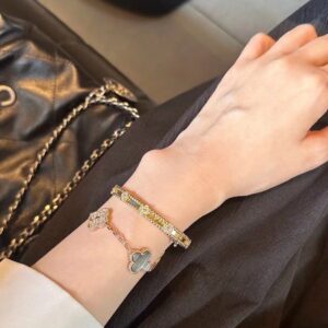 Stacked cuff bracelet and shell chain combo